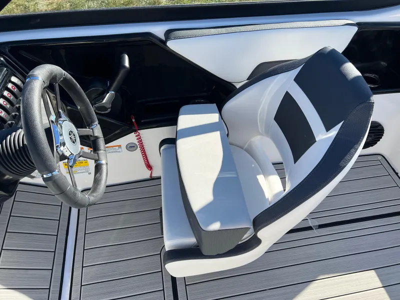 Slide: The Image of 2025 Yamaha Boats 195S cockpit with steering wheel and modern seating design. - 22