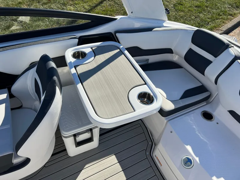 Slide: The Image of Interior seating and table of 2025 Yamaha Boats 195S, featuring cup holders and modern design. - 24