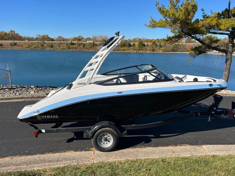 Slide: The Image of 2025 Yamaha Boats 195S on trailer by a scenic lake. - 4