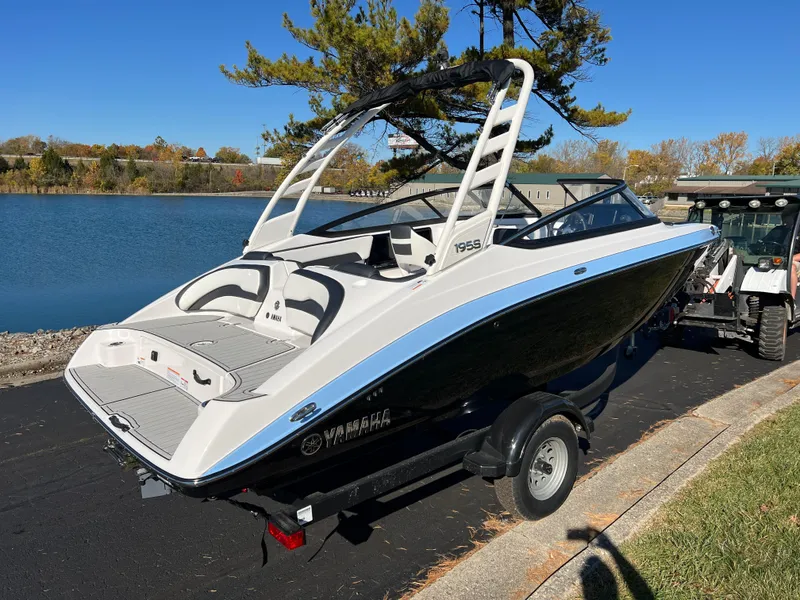Slide: The Image of 2025 Yamaha Boats 195S on trailer by a scenic lake. - 5