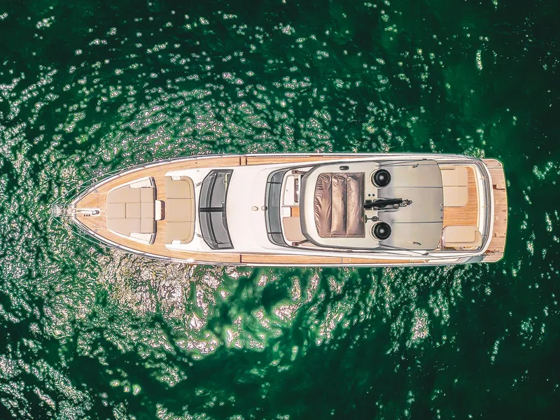 Slide: The Image of Aerial view of 2023 Azimut Fly 68 yacht on sparkling green water. - 11