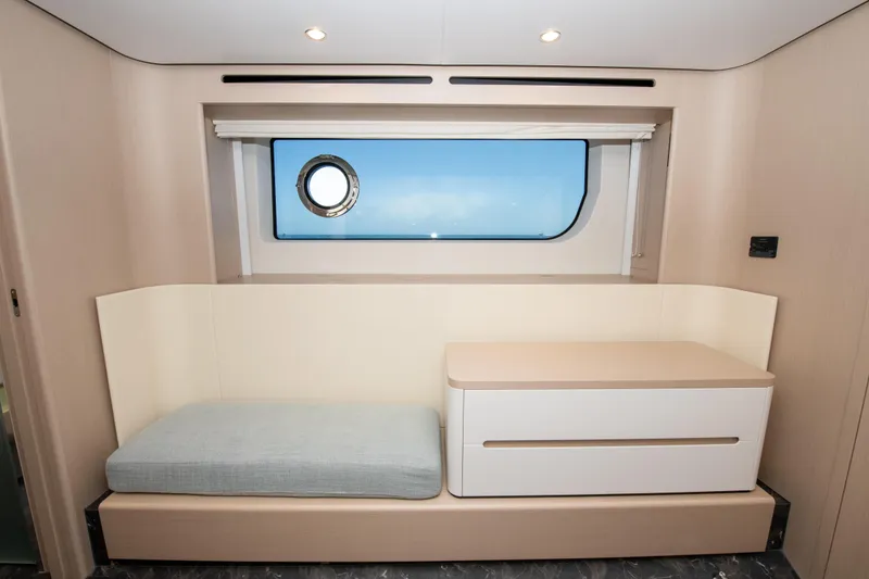 Slide: The Image of Interior of 2023 Azimut Fly 68 yacht with modern seating and window view. - 18