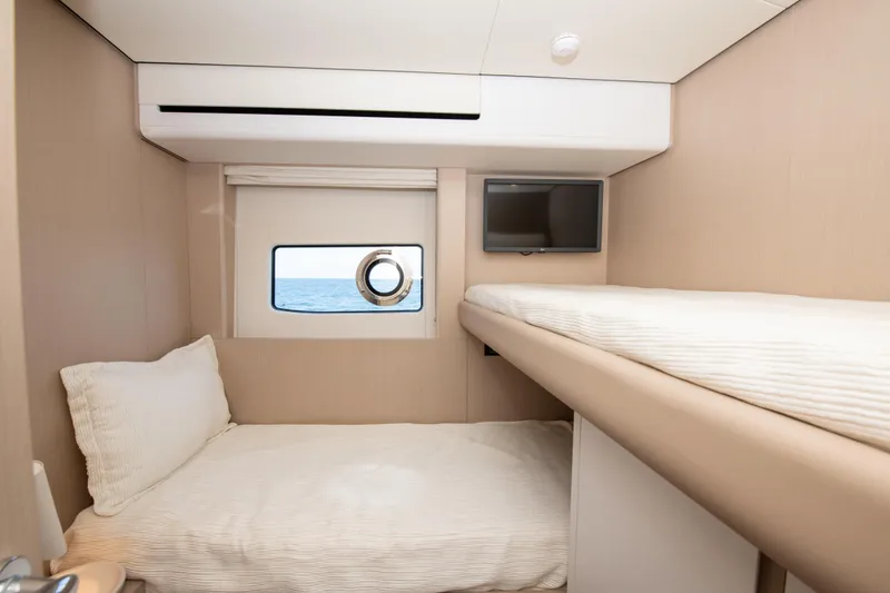 Slide: The Image of 2023 Azimut Fly 68 yacht cabin with bunk beds and ocean view. - 26