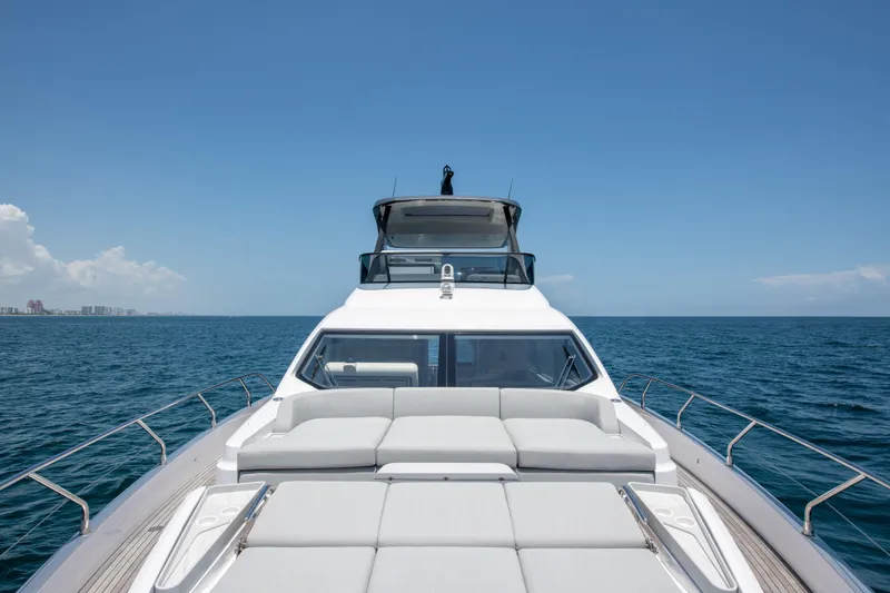 Slide: The Image of 2023 Azimut Fly 68 yacht cruising on open sea under clear blue sky. - 43