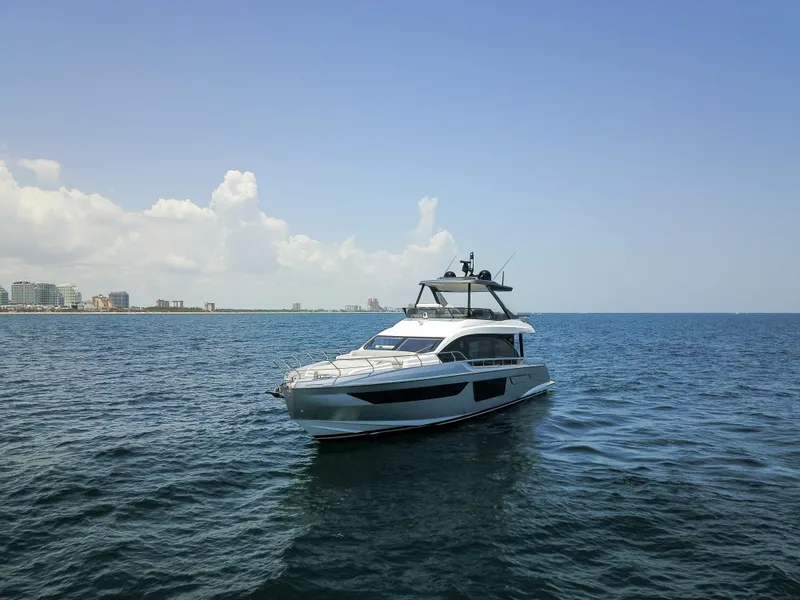 Slide: The Image of 2023 Azimut Fly 68 yacht cruising on open sea under clear sky. - 8