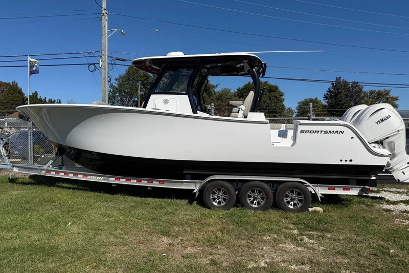 The Image of 2025 Sportsman Open 302 Center Console boat on trailer, side view. - 0