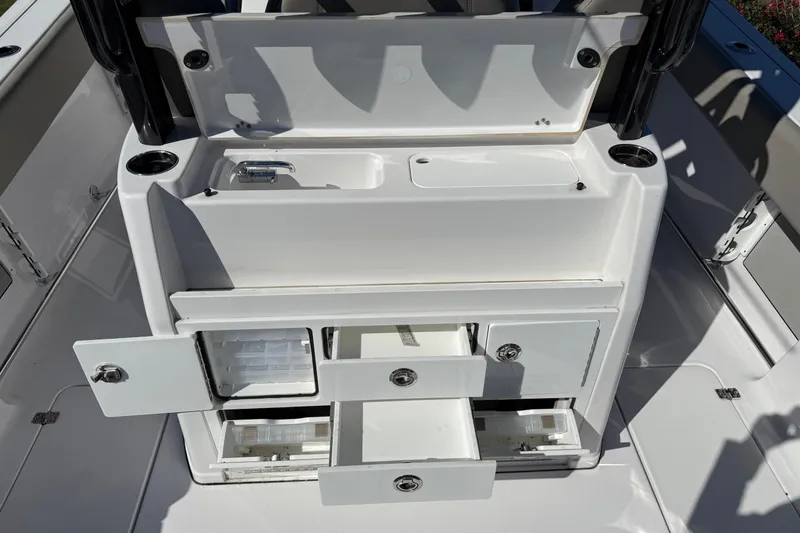 Slide: The Image of 2025 Sportsman Open 302 Center Console boat interior with storage compartments and cup holders. - 10