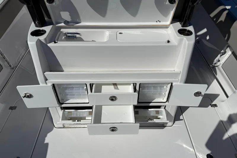 Slide: The Image of 2025 Sportsman Open 302 Center Console with open storage compartments and drawers. - 11