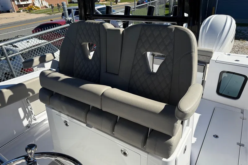Slide: The Image of 2025 Sportsman Open 302 Center Console boat with luxurious seating and modern design. - 12