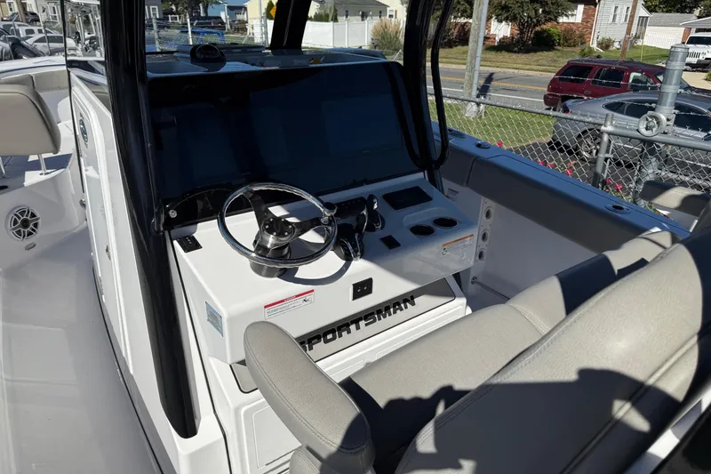Slide: The Image of 2025 Sportsman Open 302 Center Console boat interior with steering wheel and seating. - 13
