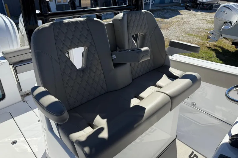 Slide: The Image of 2025 Sportsman Open 302 Center Console boat seating with armrests and diamond stitching. - 15