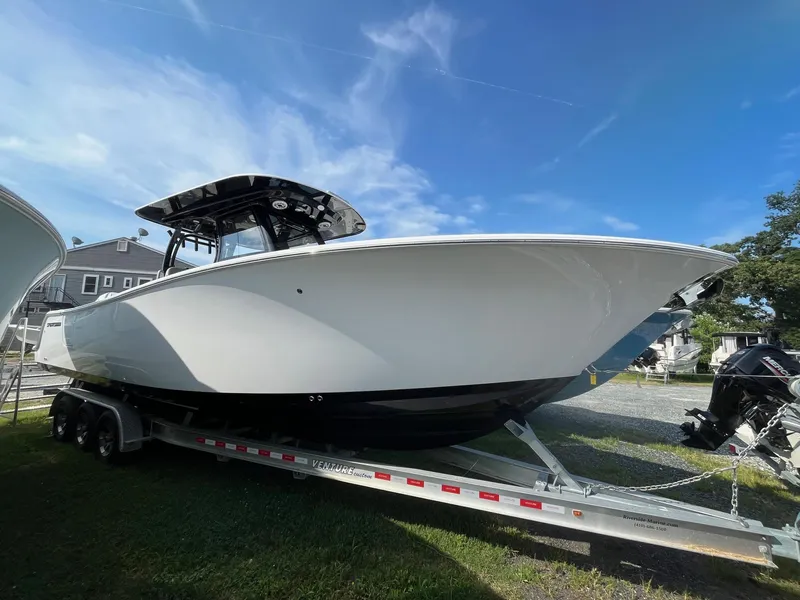 Slide: The Image of 2025 Sportsman Open 302 Center Console boat interior with cushioned seat and marine toilet. - 19