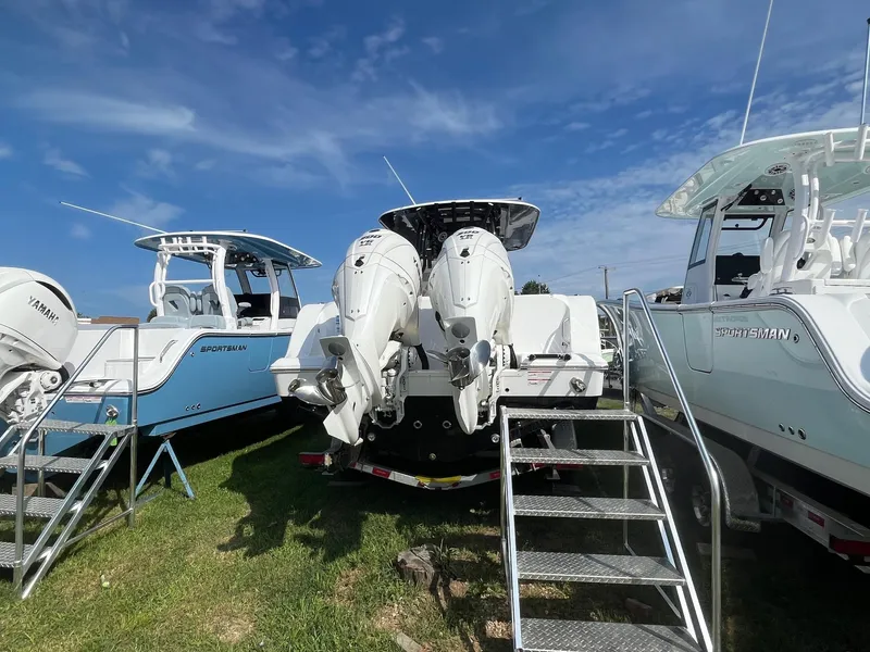 Slide: The Image of 2025 Sportsman Open 302 Center Console boat with cushioned seating and sleek design. - 20