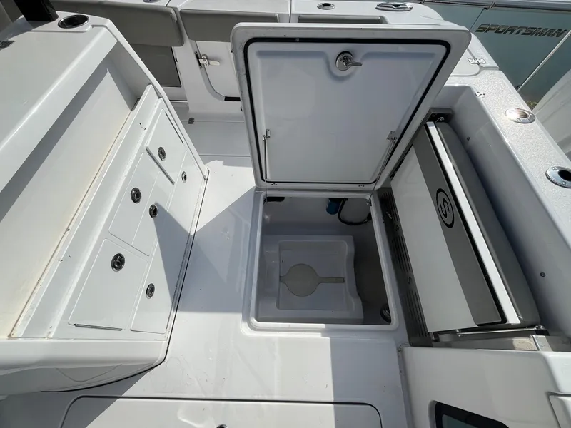 Slide: The Image of 2025 Sportsman Open 302 Center Console boat interior with seating and storage compartments. - 23