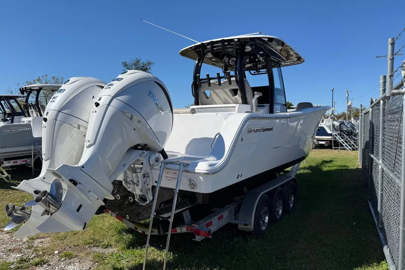 Slide: The Image of 2025 Sportsman Open 302 Center Console boat with dual Yamaha engines on a trailer. - 5