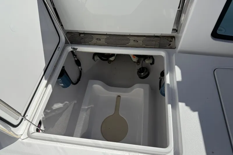 Slide: The Image of Open storage compartment on 2025 Sportsman Open 302 Center Console boat. - 8