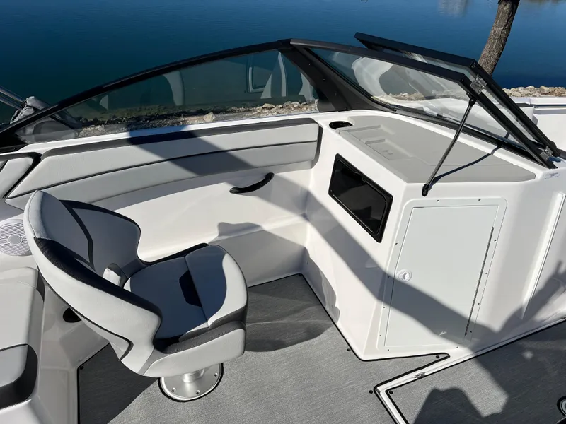 Slide: The Image of 2025 Yamaha Boats SX220 interior with sleek seating and modern dashboard design. - 12