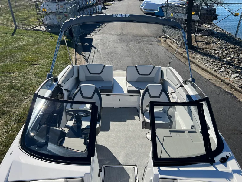 Slide: The Image of 2025 Yamaha Boats SX220, sleek interior design, docked near water. - 18