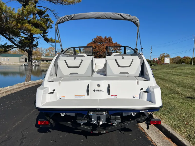 Slide: The Image of 2025 Yamaha Boats SX220 on a sunny day by the water. - 6