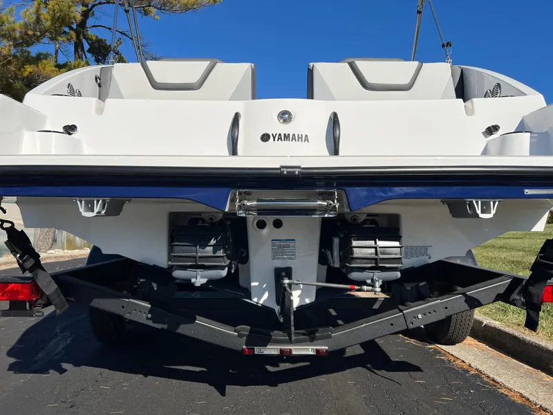 Slide: The Image of 2025 Yamaha Boats SX220 rear view on trailer, showcasing dual engines. - 7