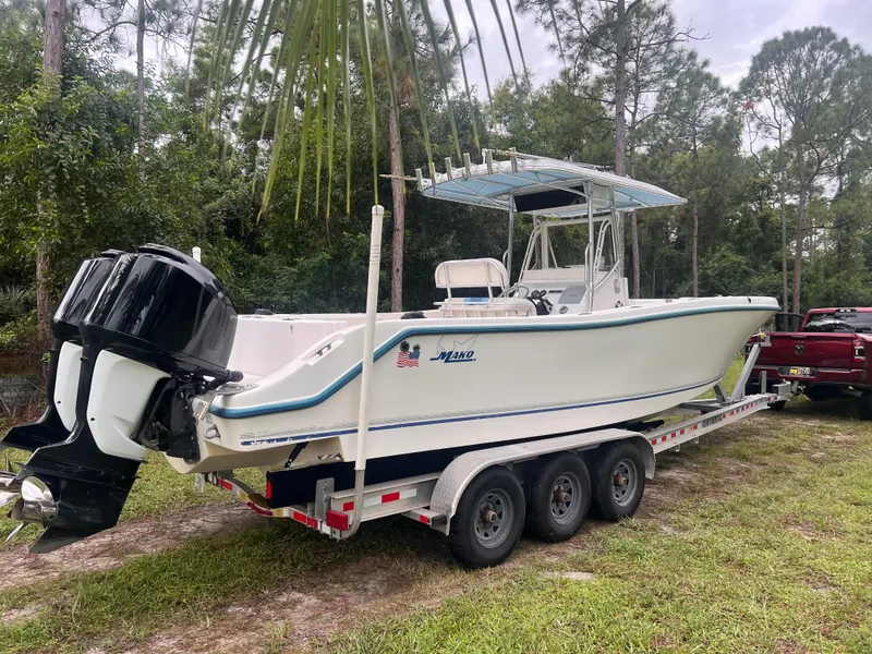 The Image of 2002 Mako 282 Center Console boat on trailer, parked outdoors. - 1