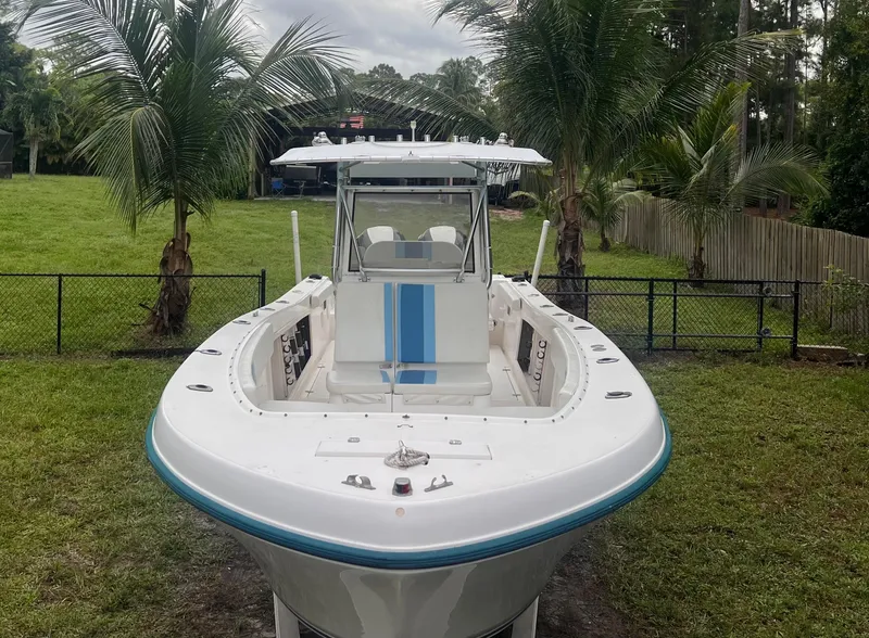 Slide: The Image of 2002 Mako 282 Center Console boat on grass with palm trees in background. - 5