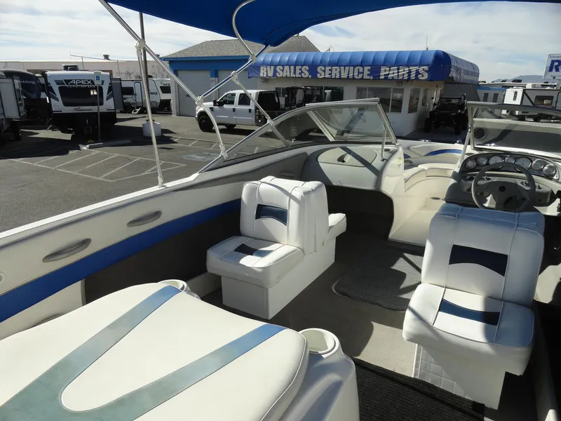 Slide: The Image of 2006 Bayliner 195 Bowrider boat interior with white seating, parked at RV sales lot. - 10