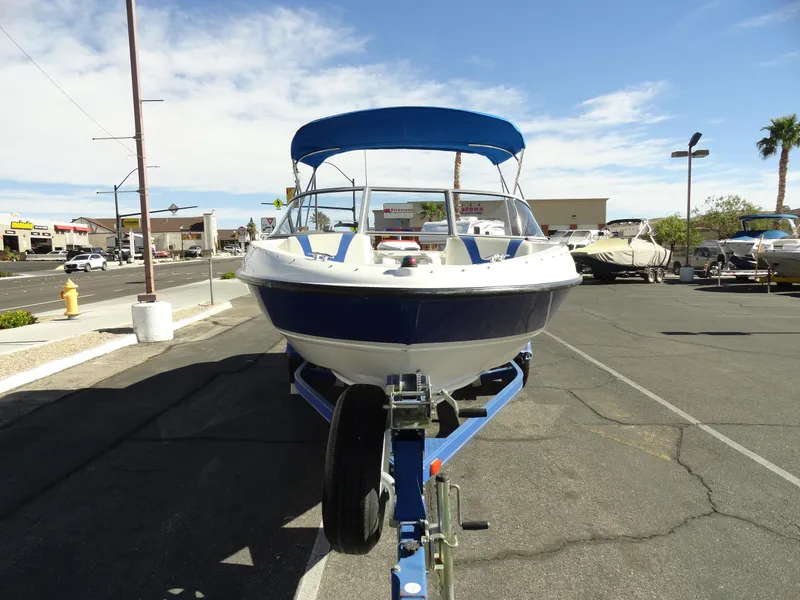Slide: The Image of 2006 Bayliner 195 Bowrider boat on trailer in parking lot, sunny day. - 3