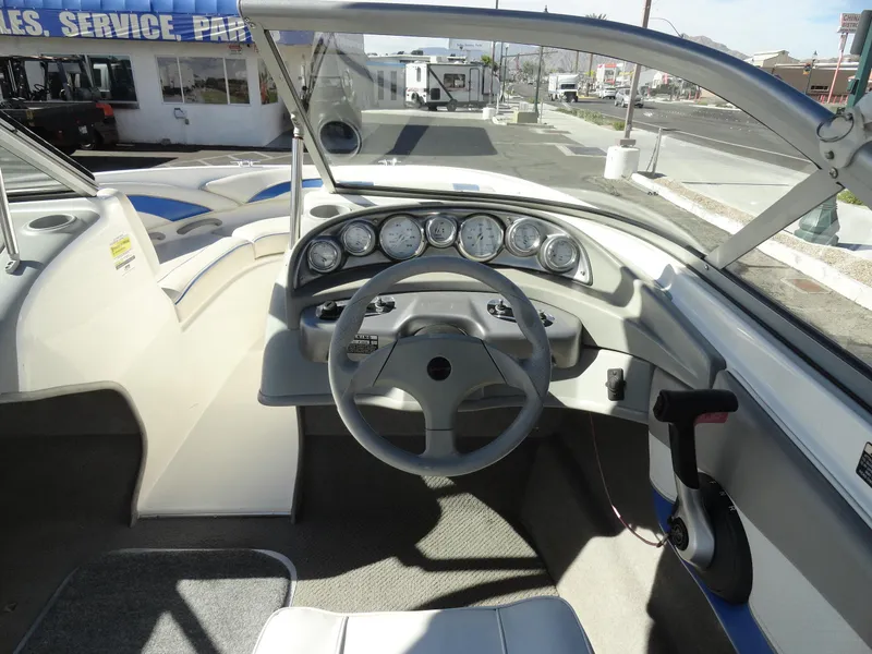 Slide: The Image of 2006 Bayliner 195 Bowrider dashboard and steering wheel, parked at a dealership. - 8