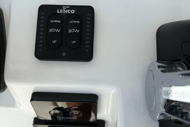 Slide: The Image of Lenco trim tab controls on 2017 Edgewater 280CC boat dashboard. - 17