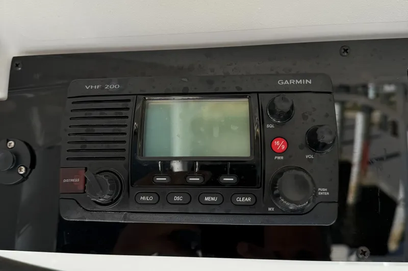Slide: The Image of Garmin VHF 200 radio on 2017 Edgewater 280CC boat dashboard. - 19