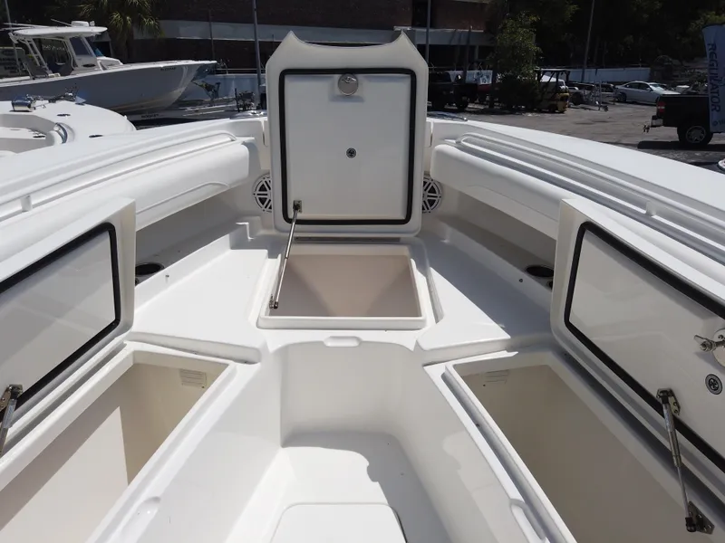 Slide: The Image of 2025 Regulator 25 boat interior with open storage compartments. - 10