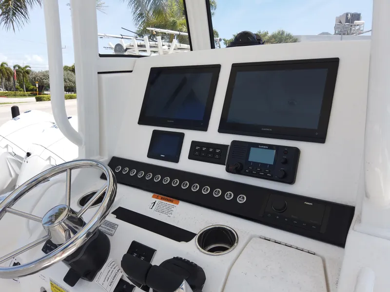Slide: The Image of 2025 Regulator 25 boat dashboard with dual screens and steering wheel. - 11