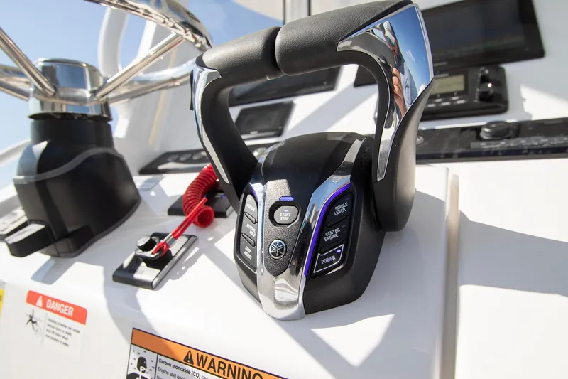 Slide: The Image of Control panel of 2025 Regulator 25 boat with modern steering features. - 14