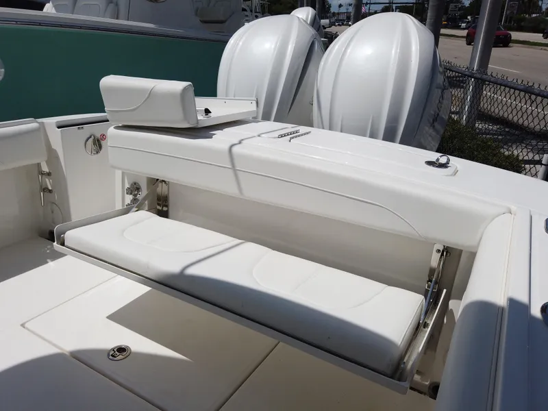 Slide: The Image of 2025 Regulator 25 boat with white seating and storage compartment. - 19