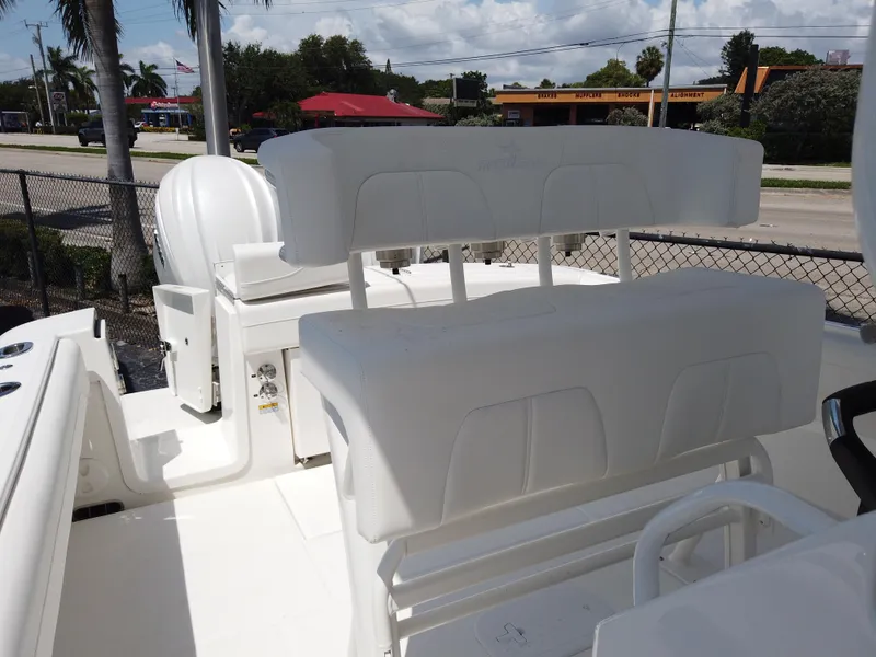 Slide: The Image of 2025 Regulator 25 boat interior with white seating and console, outdoor setting. - 21