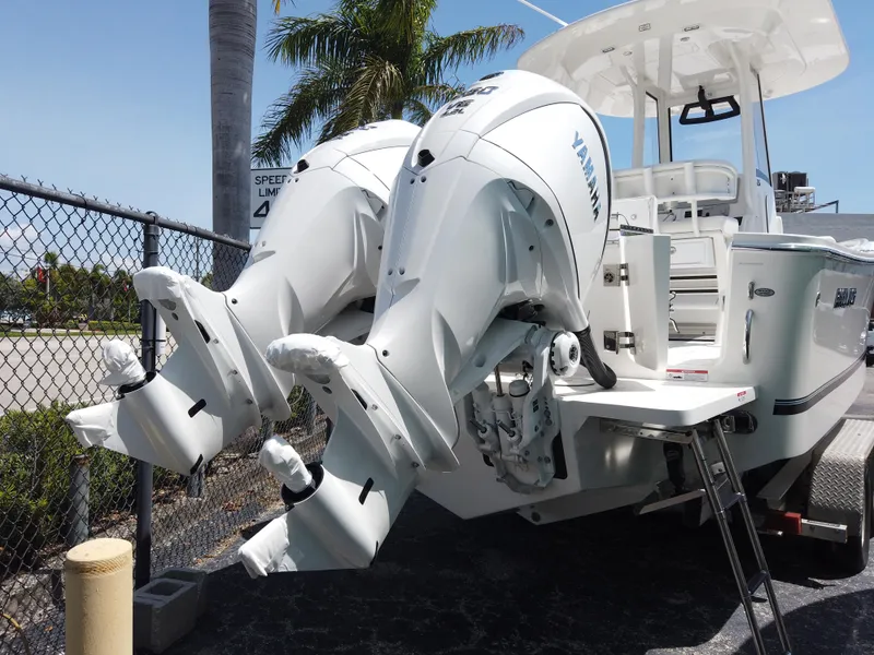 Slide: The Image of 2025 Regulator 25 boat with dual Yamaha outboard engines, parked near a fence. - 3