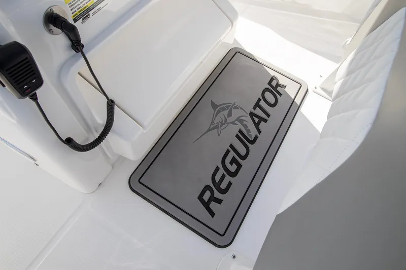 Slide: The Image of 2025 Regulator 25 boat interior with branded mat and communication device. - 8