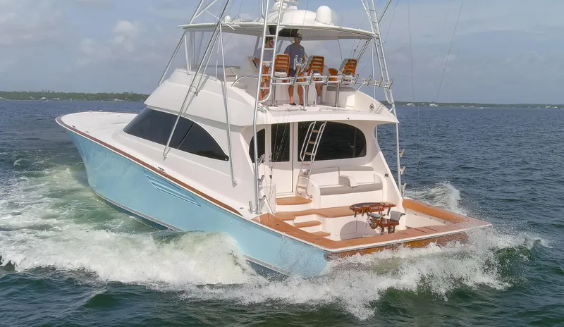Slide: The Image of 2015 Viking 70 Convertible yacht cruising on open water. - 30