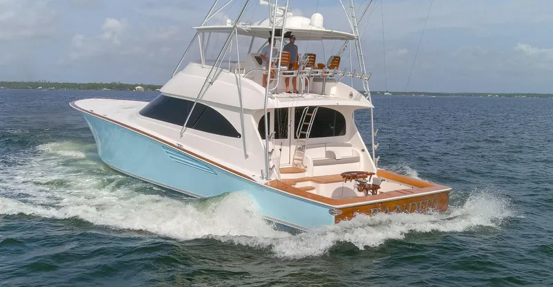Slide: The Image of 2015 Viking 70 Convertible yacht cruising on open water. - 31