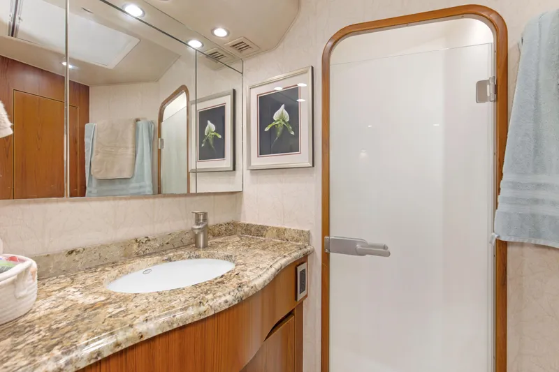 Slide: The Image of Luxurious bathroom in 2015 Viking 70 Convertible yacht with granite countertop and glass shower door. - 34