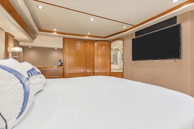Slide: The Image of Luxurious bedroom interior of 2015 Viking 70 Convertible yacht with TV and wooden accents. - 37