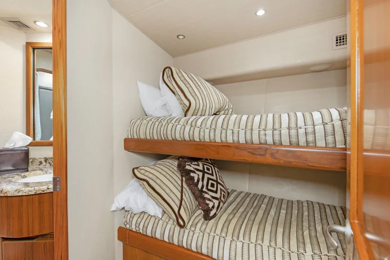 Slide: The Image of Bunk beds in 2015 Viking 70 Convertible yacht cabin with striped bedding. - 38