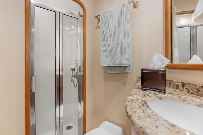 Slide: The Image of Luxurious bathroom in 2015 Viking 70 Convertible yacht with granite countertop and shower. - 39