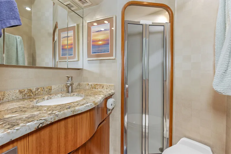 Slide: The Image of Luxurious bathroom in 2015 Viking 70 Convertible yacht with granite countertop and shower. - 41