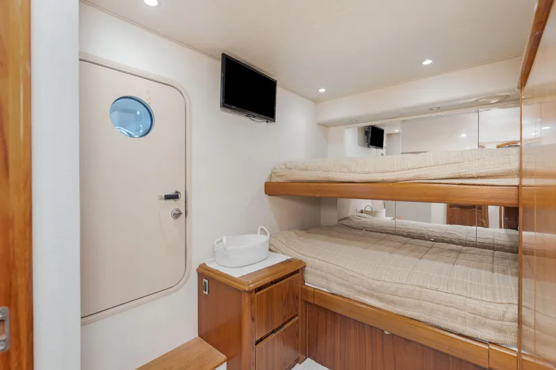 Slide: The Image of Interior of 2015 Viking 70 Convertible yacht with bunk beds and TV. - 43