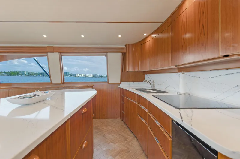 Slide: The Image of Luxurious kitchen interior of 2015 Viking 70 Convertible yacht with wooden cabinetry and marble countertops. - 47