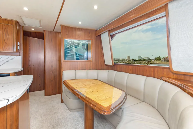 Slide: The Image of Luxurious interior of 2015 Viking 70 Convertible yacht with elegant dining area. - 49