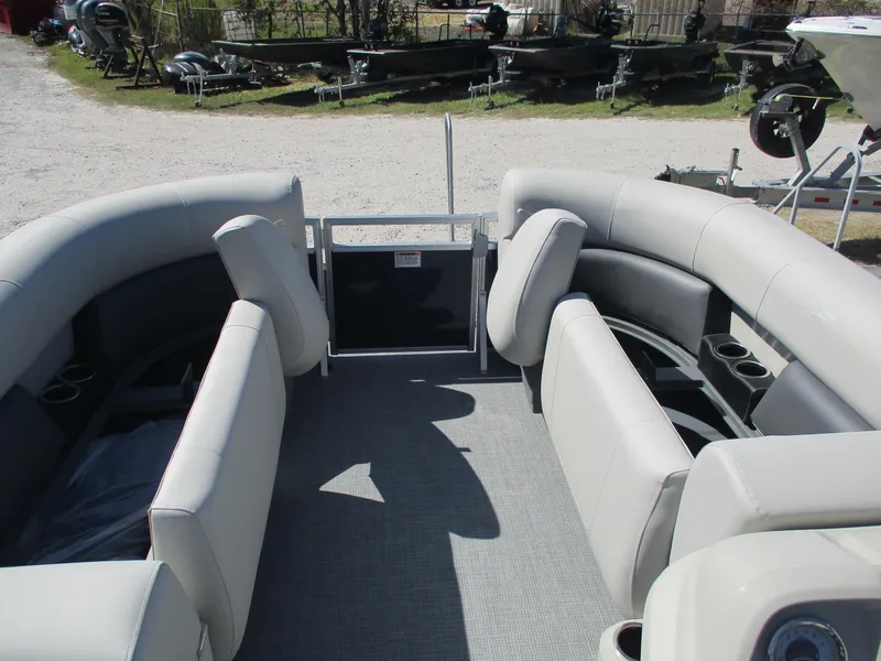 Slide: The Image of 2025 Starcraft LX16R pontoon boat interior with plush seating and cup holders. - 10
