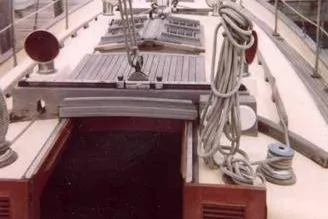 Slide: The Image of 1984 Young Sun 35 sailboat docked at marina, featuring classic design and wooden details. - 2